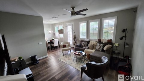 A living room with a brown leather chair and a rug.