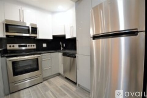 A kitchen with a stainless steel refrigerator and oven.
