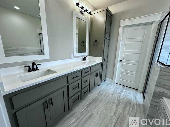 A bathroom with a sink, mirror, and cabinets.