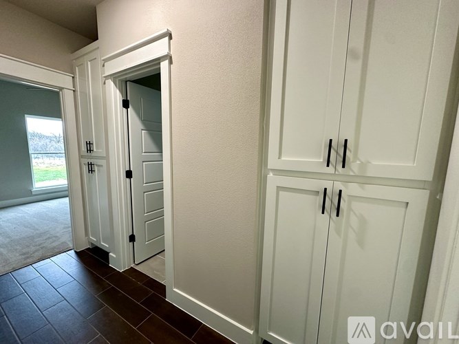 A white cabinet with a door open is in the foreground.