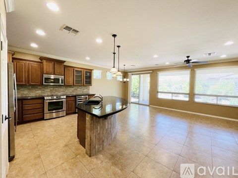 A spacious kitchen with wooden cabinets and a central island.