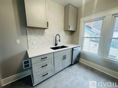 A kitchen with a sink and cabinets.