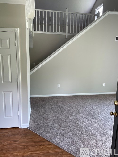 A room with a staircase and a door.