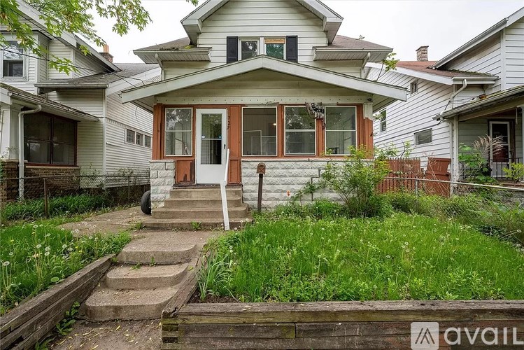 A house with a front yard and a wooden fence.
