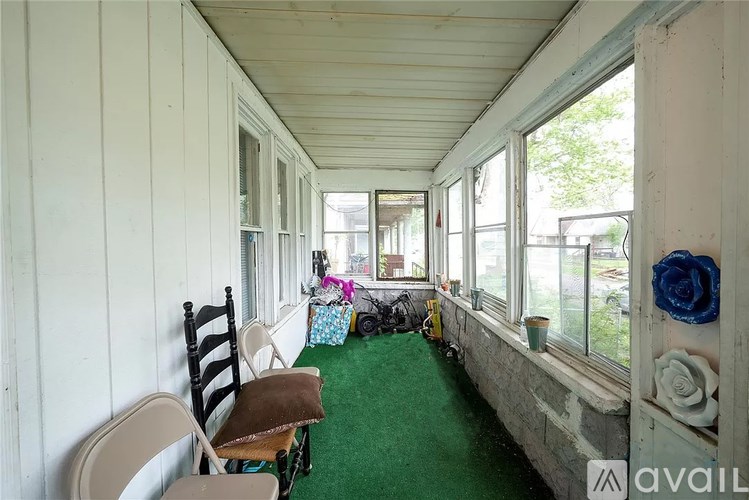 A balcony with chairs and a table.