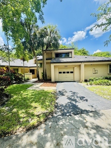 A house with a driveway and garage in front of it.