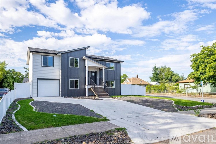 A modern two-story house with a garage is available for sale.