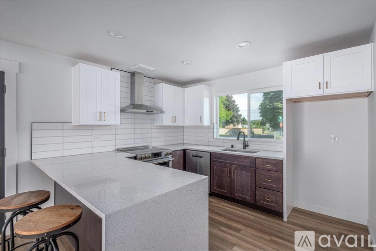 A kitchen with white cabinets and a large island.