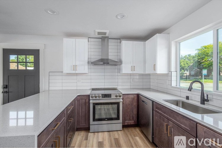 A kitchen with white cabinets and a dark oven.