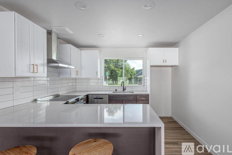 A modern kitchen with white cabinets and a large island.