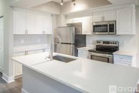 A kitchen with white cabinets and stainless steel appliances.