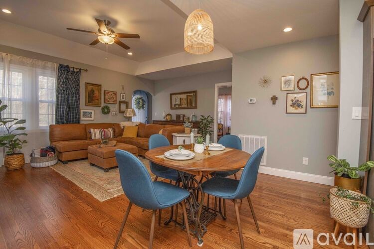 A dining room with a wooden table surrounded by blue chairs.
