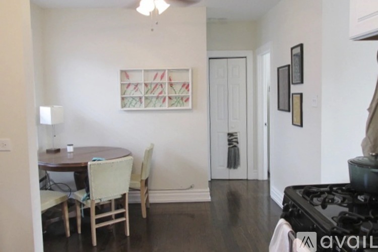 A dining room with a table and chairs.