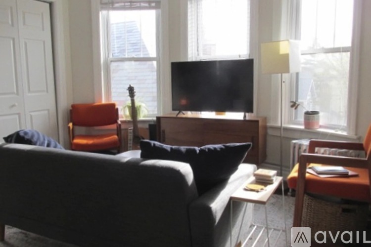 A bedroom with a bed, a dresser, and a window.