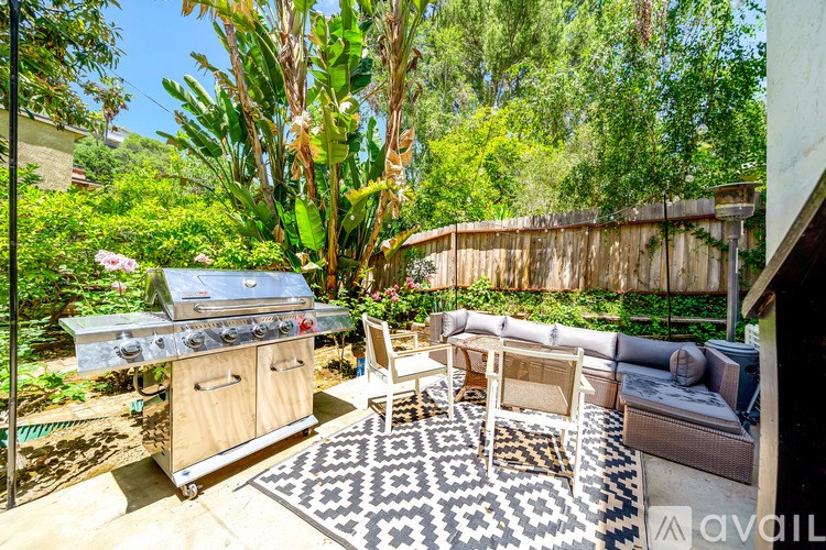 A backyard with a grill and seating area.