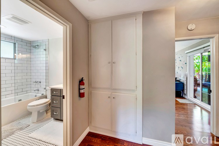 A bathroom with a tub, toilet, and sink.