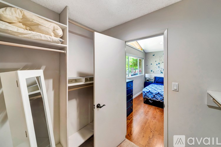 A bedroom with a bed, dresser, and mirror.