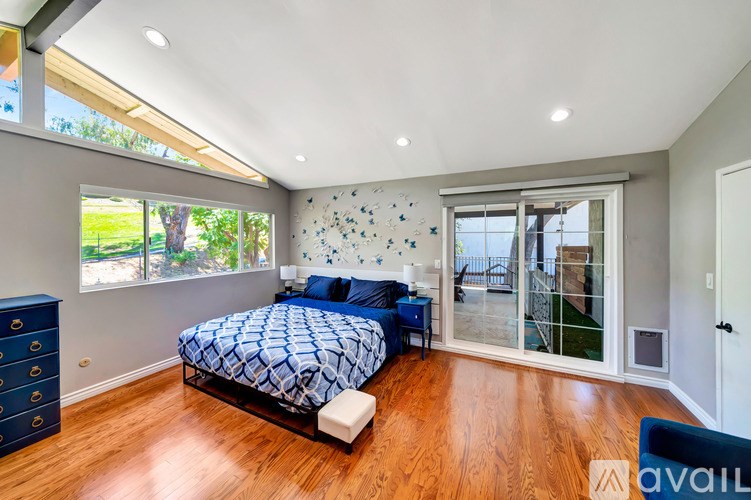 A bedroom with a bed and a dresser.