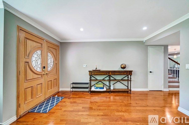 A wooden door with a glass window is on the left side of the image.