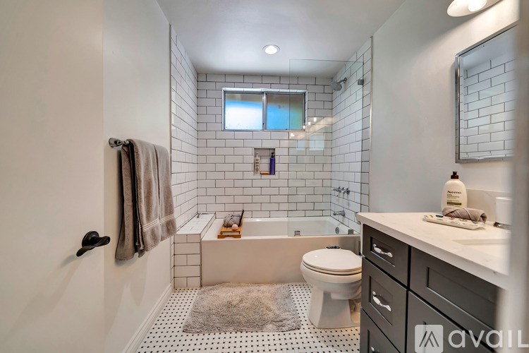 A bathroom with a toilet, sink, and a bathtub.