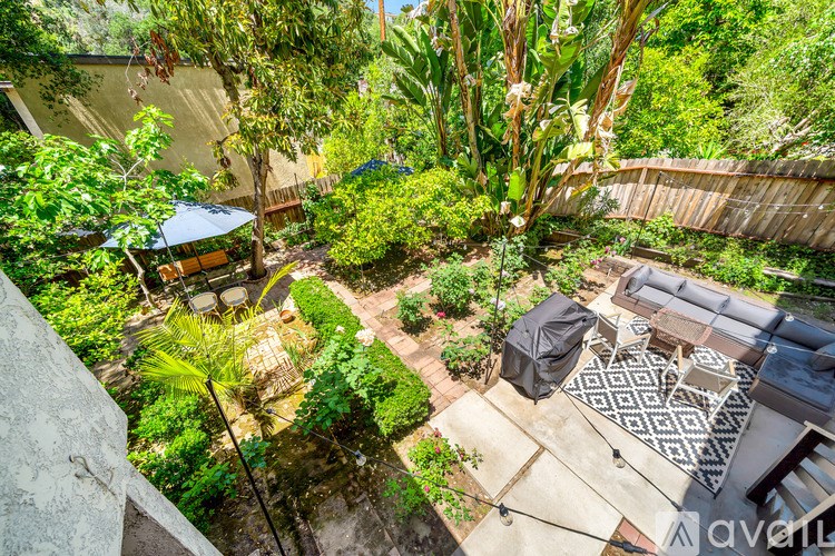 A backyard with a patio and a grill.