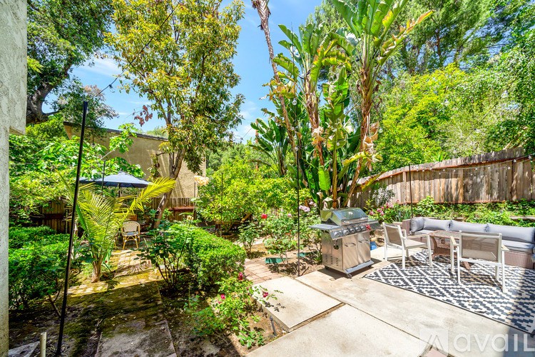 A backyard with a patio and a pool table.