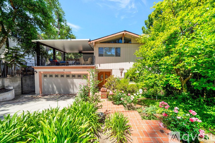 A house with a garden in front of it.