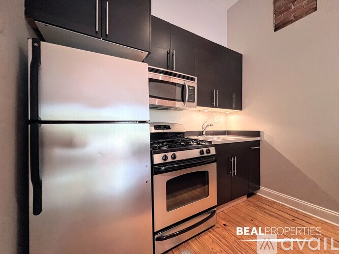A kitchen with black appliances and white countertops.