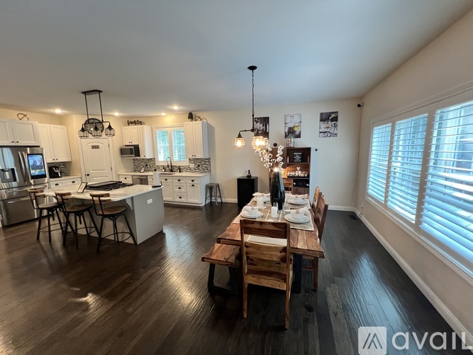 A well-lit kitchen with a dining table set for two.