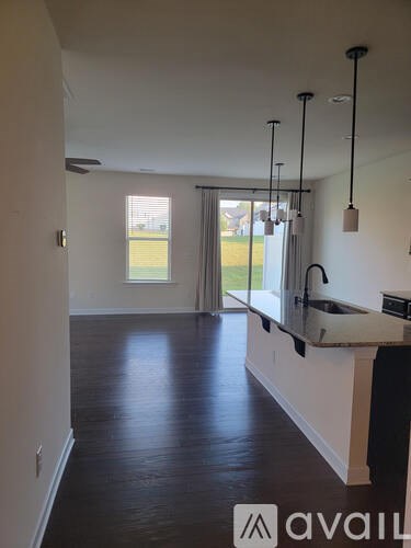 A kitchen with a sink and a window.