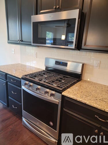 A kitchen with a black oven and microwave.