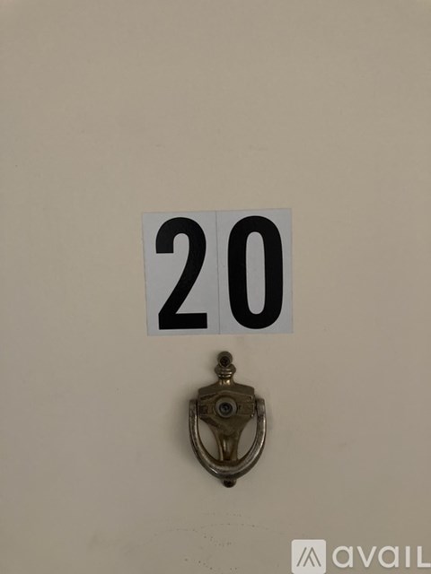 A door handle is below a number 20 sign.