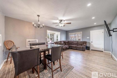 A living room with a dining table and chairs.