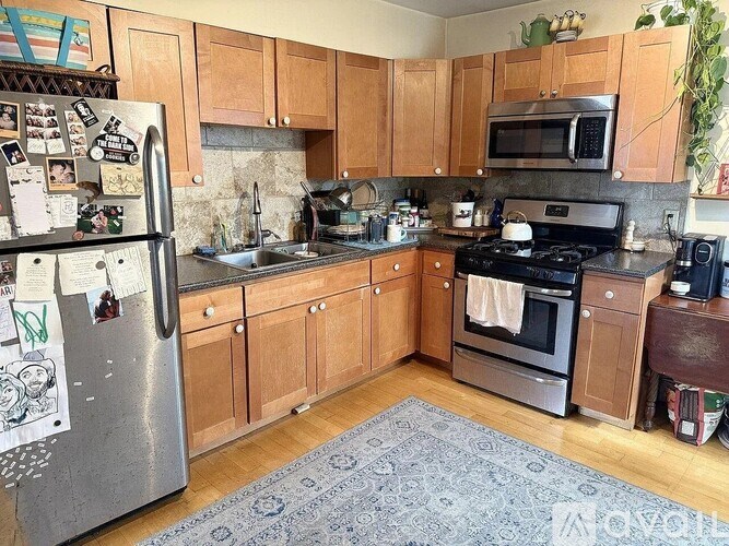 A kitchen with wooden cabinets and a refrigerator covered in magnets.