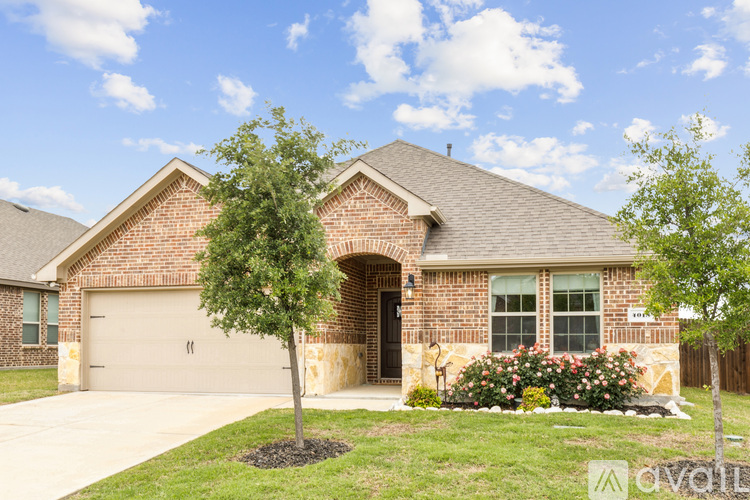 A house with a brick facade and a large front yard.