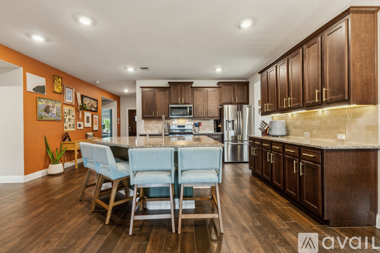 A kitchen with a table and chairs in the middle of the room.
