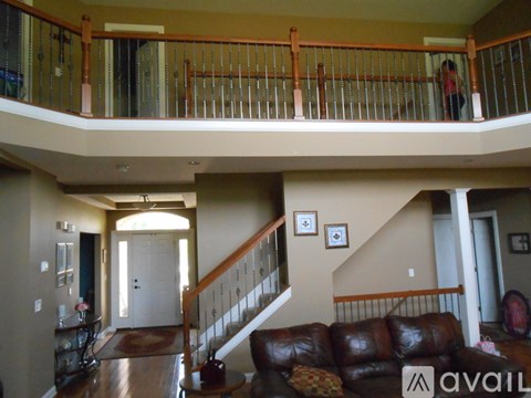 A living room with a couch and a staircase.