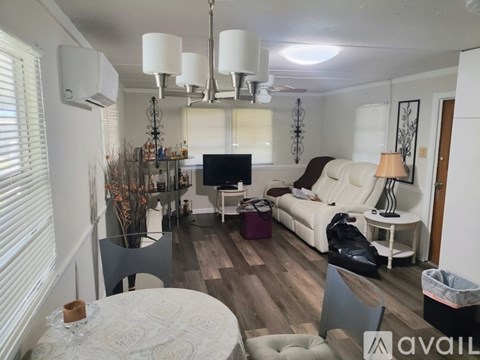 A living room with a white couch and a television.