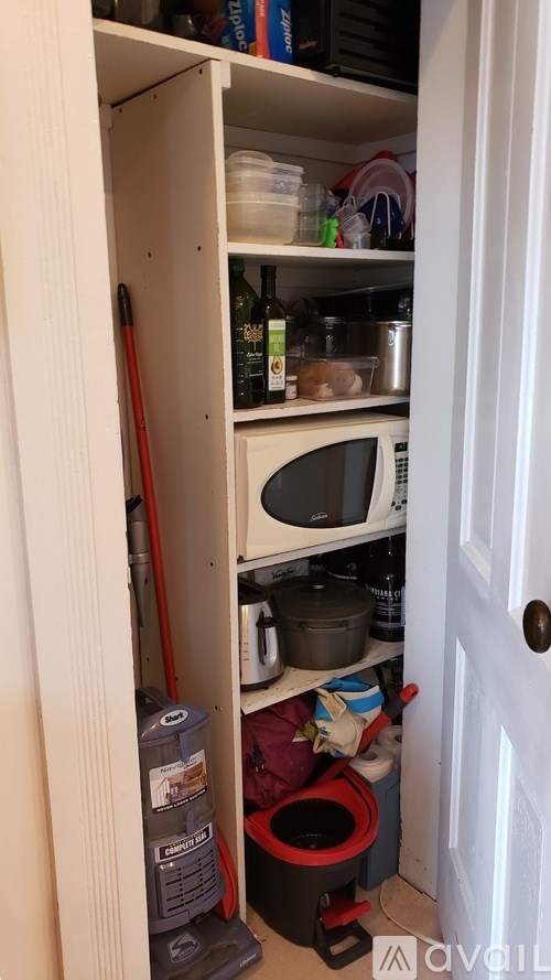 A small kitchen with a microwave and a toaster oven.