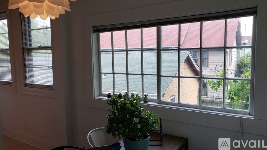 A room with a window overlooking a house.