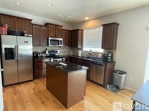 A kitchen with wooden cabinets and stainless steel appliances.
