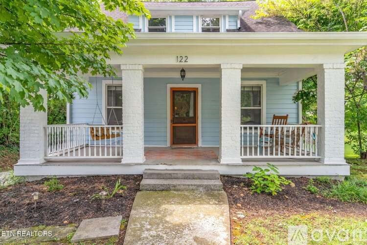A house with the number 122 on the front porch.