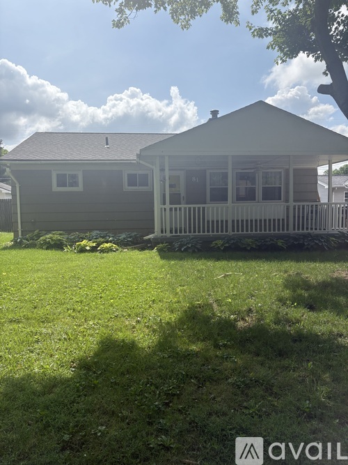 A house with a white picket fence in front of it.