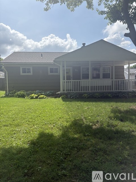 A house with a white picket fence in front of it.