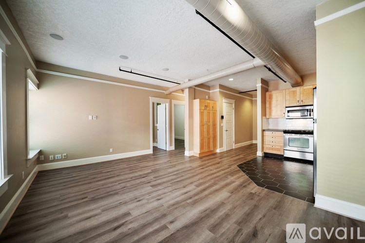 A spacious kitchen with wooden flooring and a modern design.