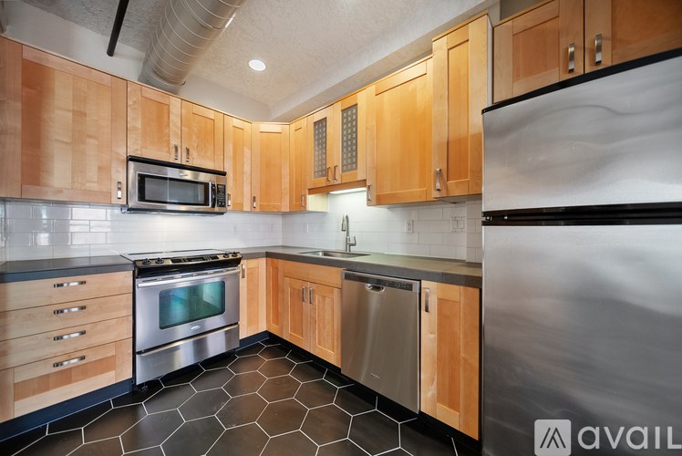 A kitchen with wooden cabinets and stainless steel appliances.