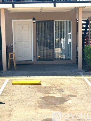 A white door with a glass window is open.