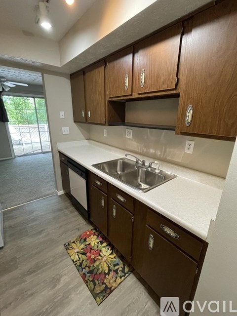 A kitchen with wooden cabinets and a white countertop.