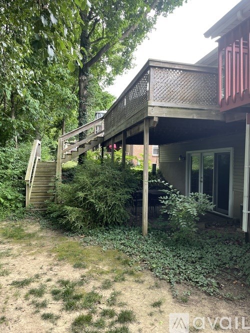 A house with a porch and a staircase leading to it.
