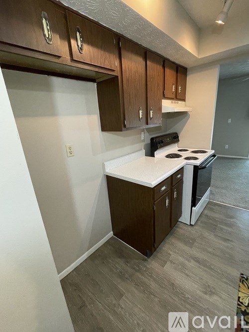 A kitchen with wooden cabinets and a white countertop.